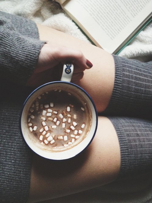 Mug with marshmallows and book