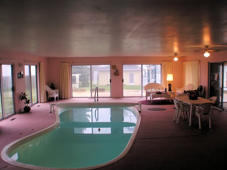 Indoor pool surrounded by warm finishes