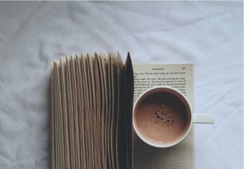White mug on open book