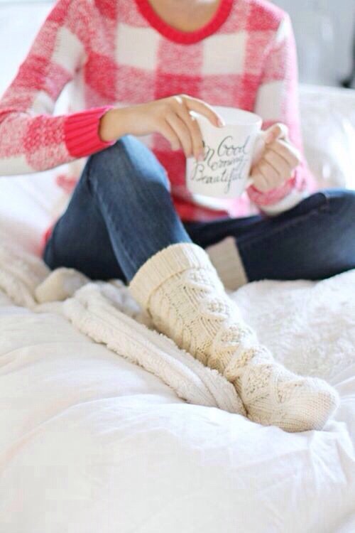 Person in plaid sweater holding morning mug