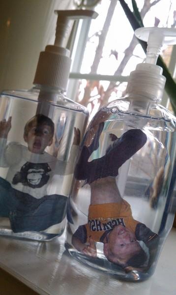 Take photos, cut them out and glue onto white paper. Then photo copy onto transparency paper, cut out image and roll it up so that it can fit into the top of a soap bottle. Fill with clear soap. photo soap bottle craft