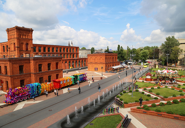People near Olek crocheted locomotive installation