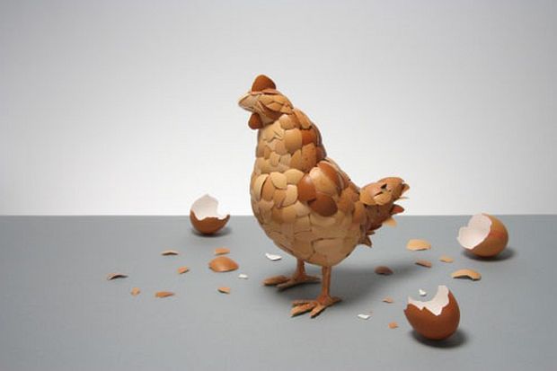 Chicken sculpture covered in overlapping brown eggshell fragments