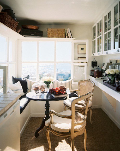 Window bench with cane chairs city view and high storage shelf