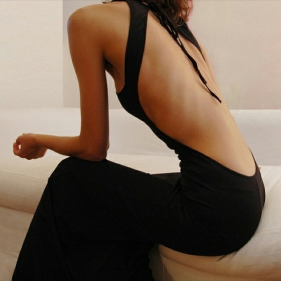 Studio fashion image of a woman’s back and clothing structure