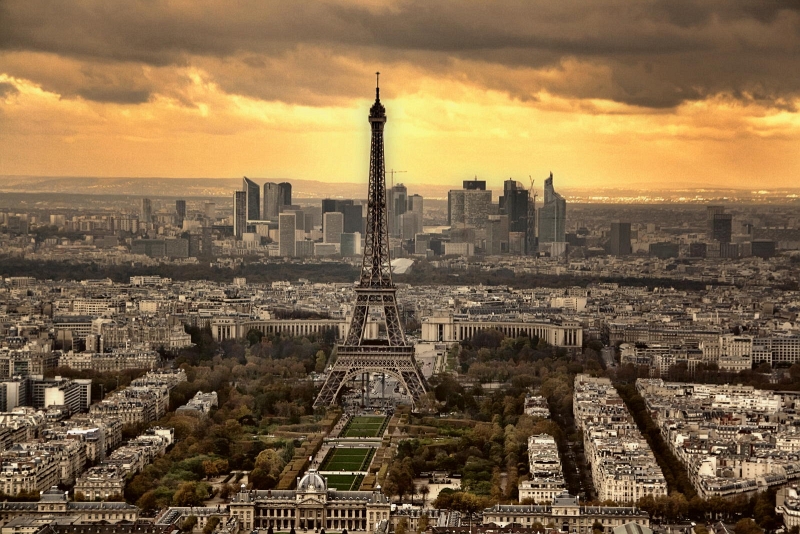 Symmetrical aerial of the Eiffel Tower over Champ de Mars at golden sunset