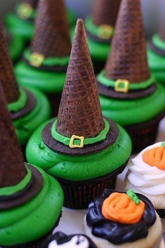 Witch hat cupcakes with green frosting and chocolate cones