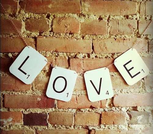 Scrabble letter tiles arranged for a craft project