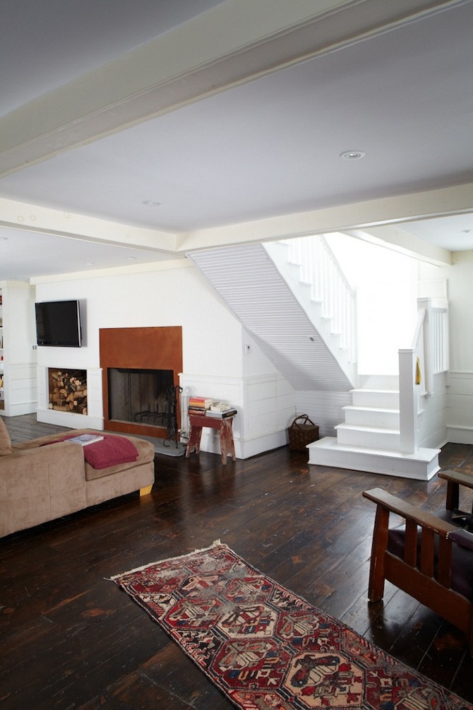 Double-height interior with fireplace and mixed materials