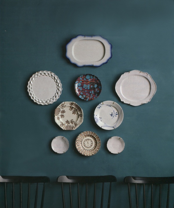 Mixed antique plates hung as a wall feature