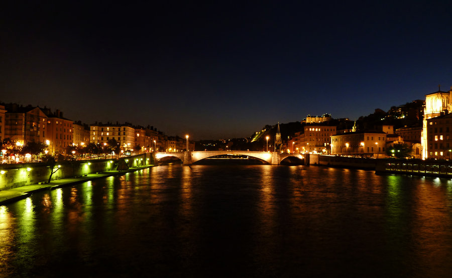 City nightscape with warm building lights and dark sky