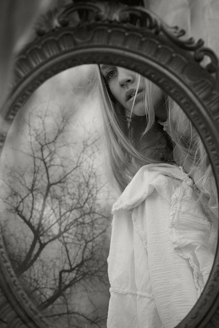 Woman regarding her reflection