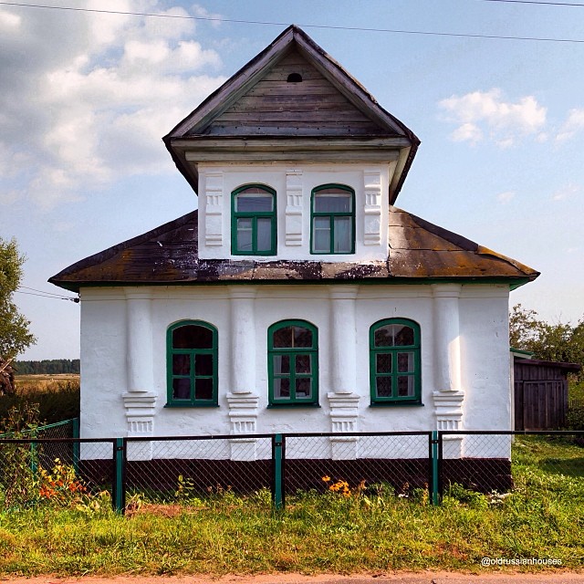 Colorful wooden house with carved window surrounds