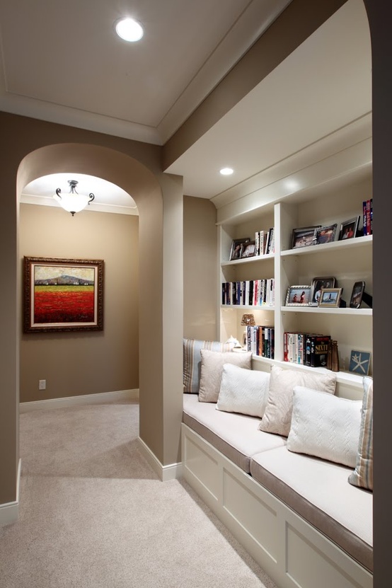 Hallway built-in reading nook with bookshelves and pillows