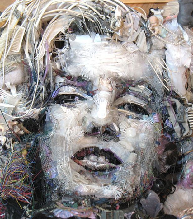 Assemblage portrait built from wires, plastic forks, mesh, and scrap parts