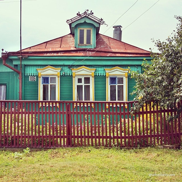 Old wooden dwelling with porch and fence