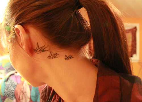 three swallow tattoos behind ear toward neck