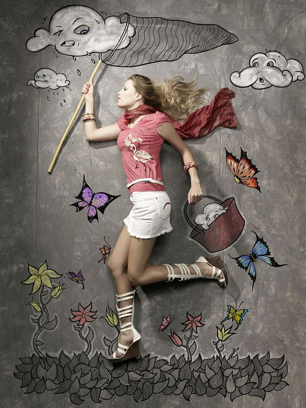Woman running with a butterfly net catching chalk clouds among flowers
