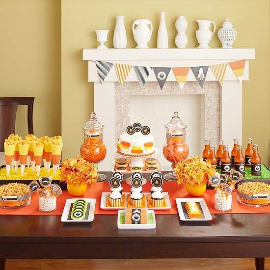 Candy-corn color palette dessert table with popcorn cones