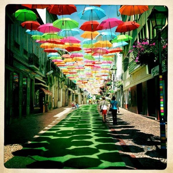 Colourful umbrellas suspended above a Portuguese street