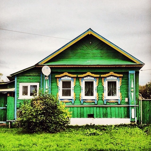 Wooden Russian house with decorative roof edge