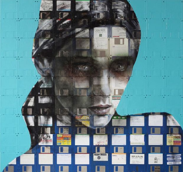 Woman’s portrait painted on a large grid of teal and gray floppy disks