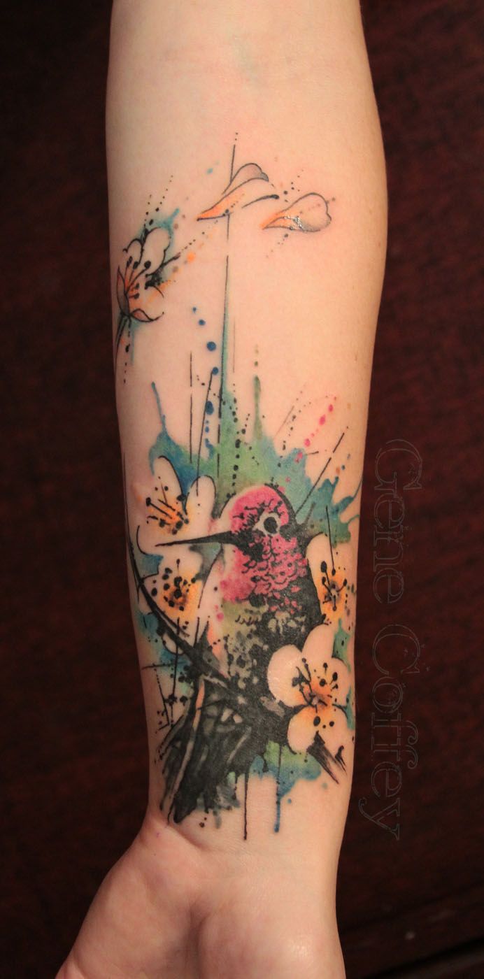 Hummingbird and blossom watercolour tattoo on the forearm