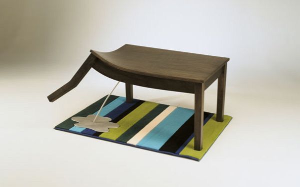 Coffee table with a raised leg and puddle detail