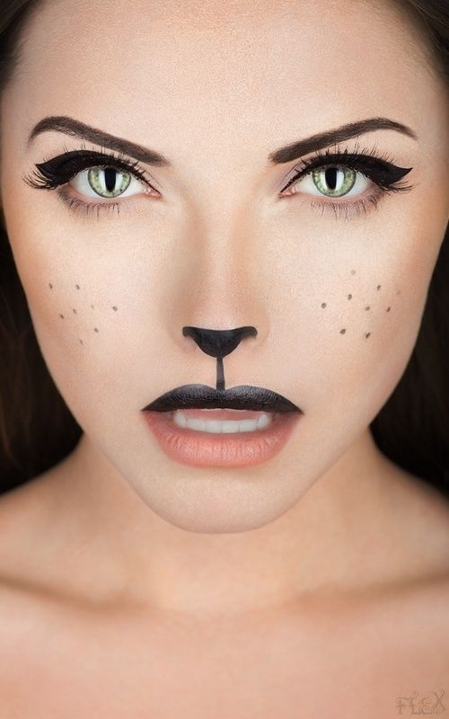 Glam cat makeup with slit-pupil green contacts