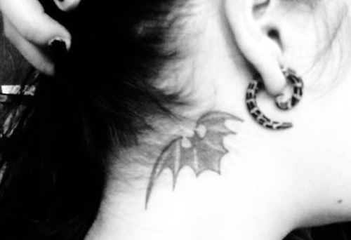 shaded wing tattoo behind the ear