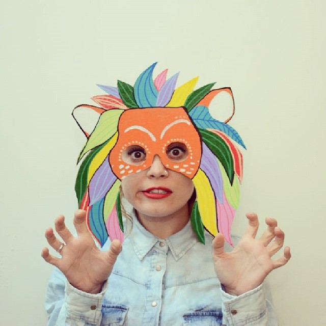 Colorful lion forest-spirit cardboard mask with claw pose