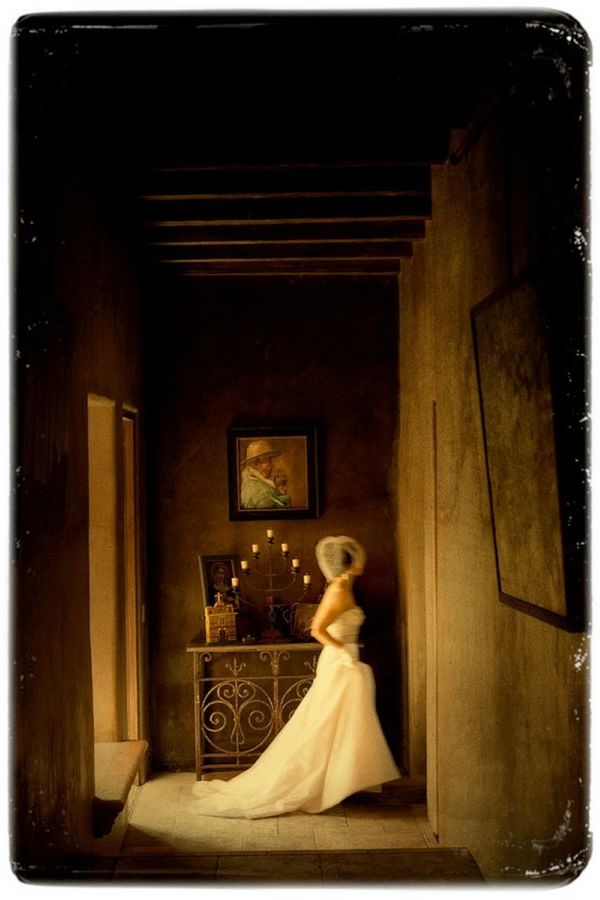Bride walking through a dark historic hallway in motion