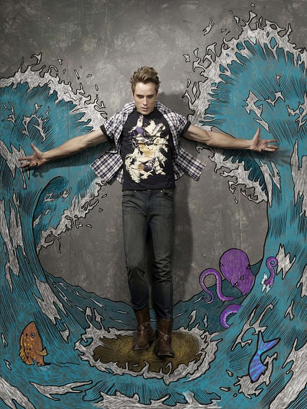 Man standing amid chalk ocean waves with octopus and fish