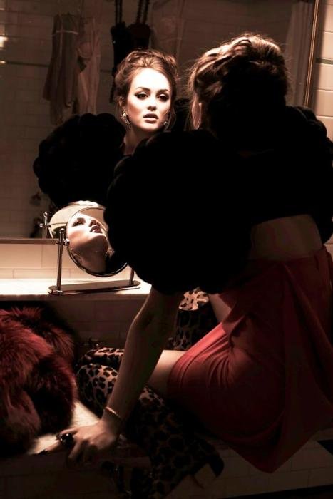 Woman facing her mirrored image