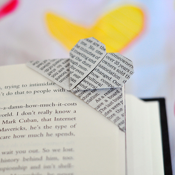 Finished heart origami page corner bookmark on a book