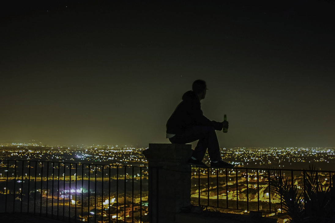 Night city panorama with layered hills of lights