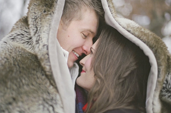 Winter engagement couple in snowy outdoor scene