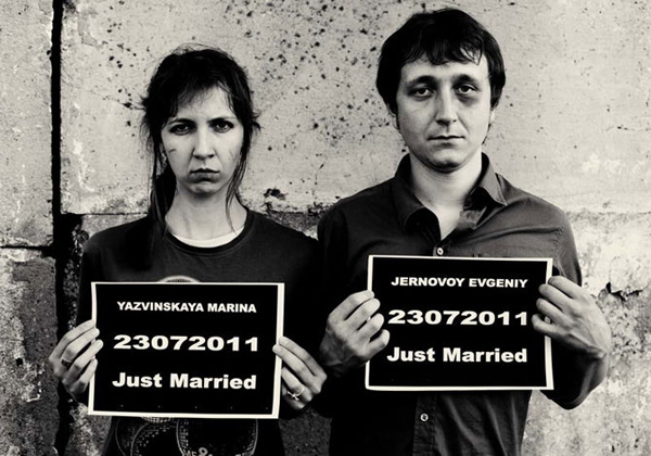 Black-and-white just married mugshot parody with name placards