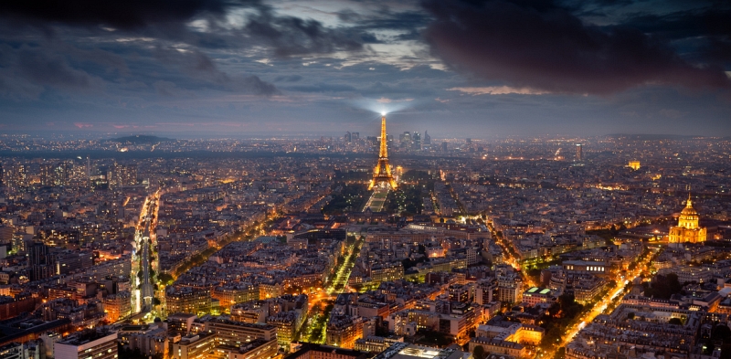 Aerial night view of Paris with the glowing Eiffel Tower and Les Invalides