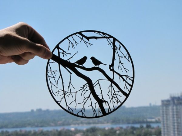Black paper cutting held to light