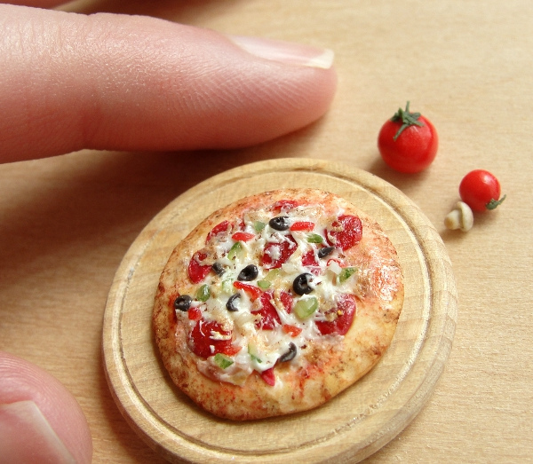 delicious-mini-foods10 Miniature pepperoni pizza on a wooden board with tiny tomatoes