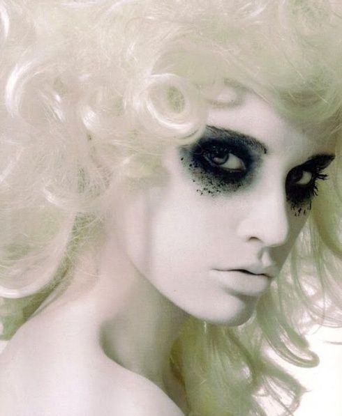 Ghostly white face with splattered dark eye makeup