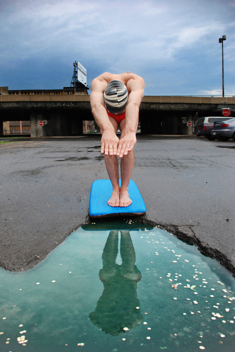 Imaginative tableau staged inside an urban pothole
