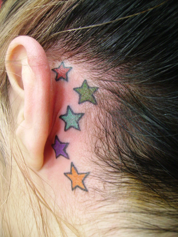 five colored stars tattoo behind the ear