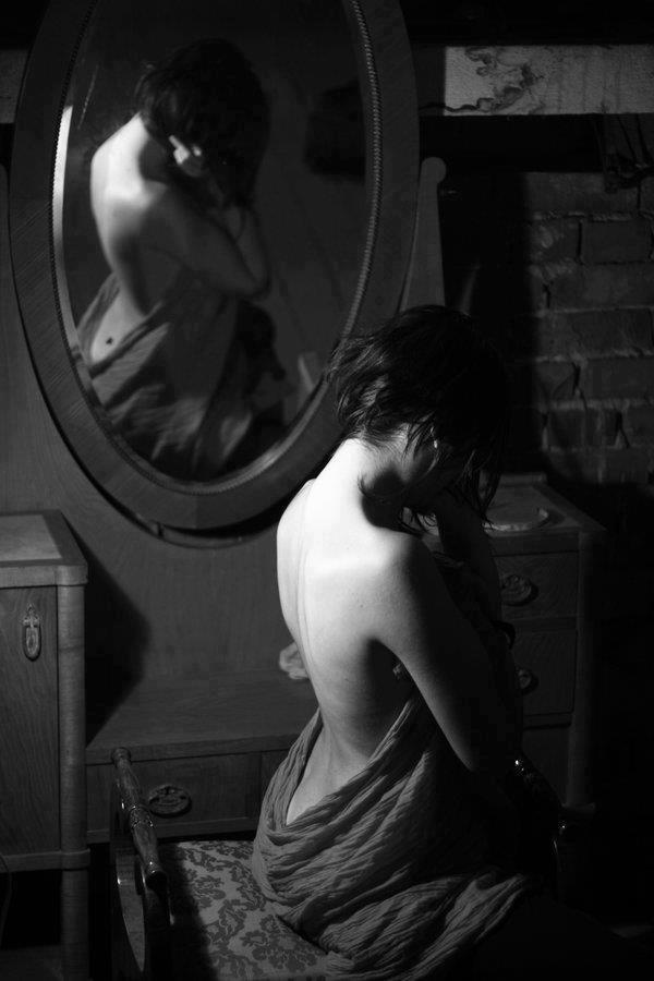 Contemplative mirror photograph of a woman