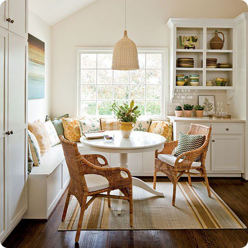 Coastal cottage banquette with wicker chairs and woven pendant