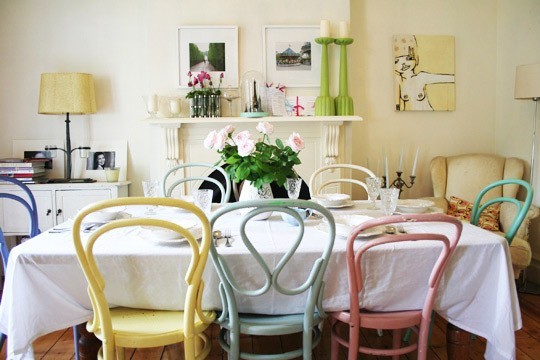 Dining room with mismatched pastel chairs