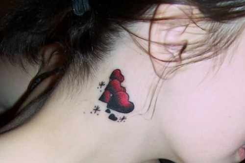 red hearts and sparkles tattoo behind the ear