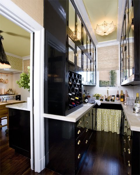 Kitchen pantry interior showing labeled jars and cooking oils