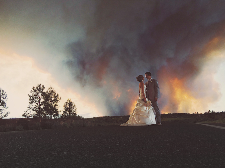 Wildfire wedding portrait of the couple against smoke and sky near Bend